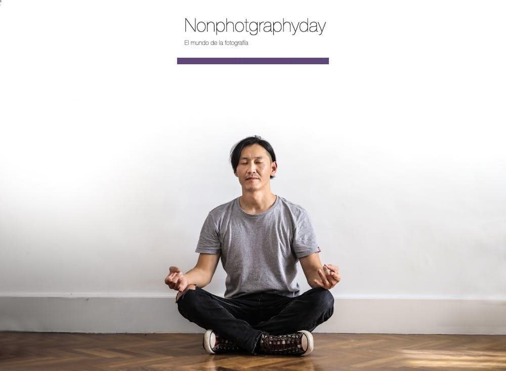 Photo of Man in Gray T-shirt and Black Jeans on Sitting on Wooden Floor Meditating