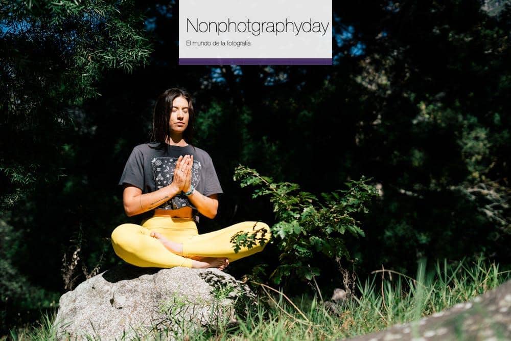 Photo of Woman Doing Yoga While Sitting on Rock